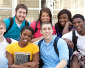 Image: Group of college students sitting on steps in front of building