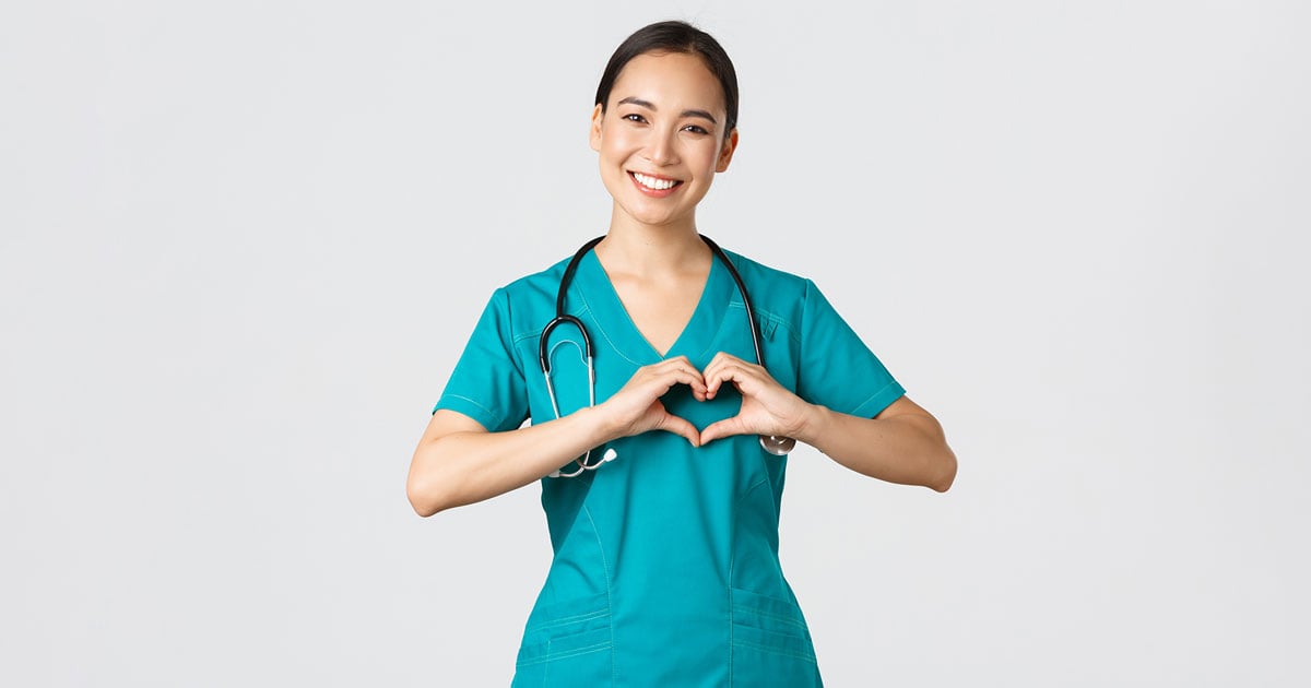 Image: Healthcare professional making heart gesture with hands.
